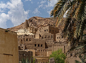 L&rsquo;antico villaggio di fango di Birkat al Mawz si armonizza perfettamente con la montagna che lo sovrasta.