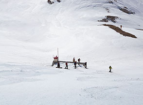 Scialpinisti si &ldquo;appoggiano&ldquo; sul tetto, semicoperto dalla neve, del Rifugio Garibaldi.