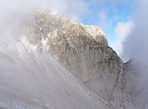 Tra le nuvole appare la cresta nord-orientale dello Sperone di Mezzo.
