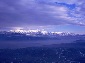 Il gruppo del Gran Sasso emerge dalla foschia mattutina, illuminato dal sole (dal Passo della Forca, Torninparte).